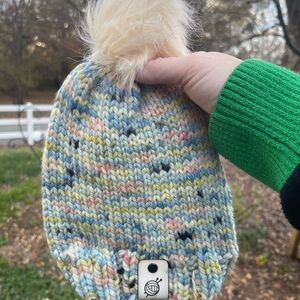 Hand knit beanie with faux fur pom pom